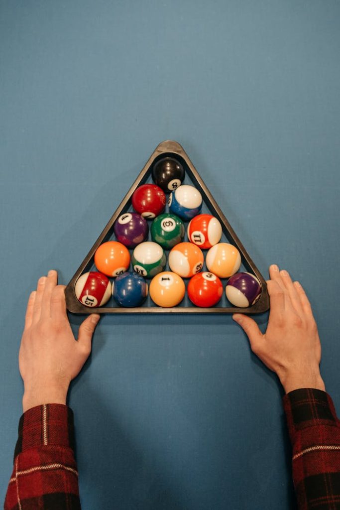 A Person Holding a Rack with Billiard Balls